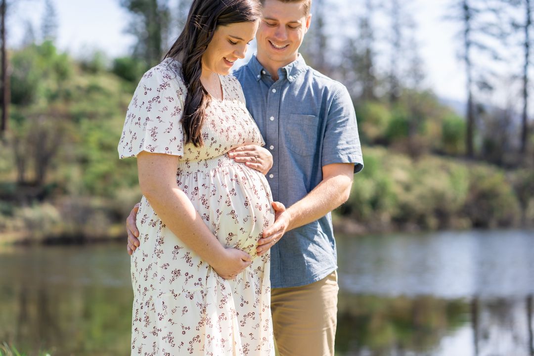 young parents cradle the baby bump