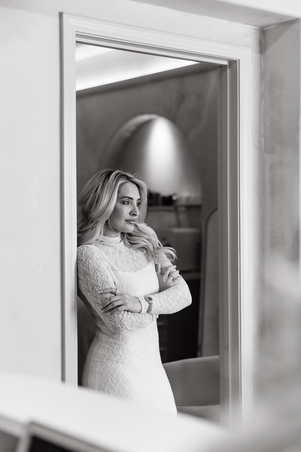 A series of three black and white photos showing a bride in a white lace wedding dress through window reflections.