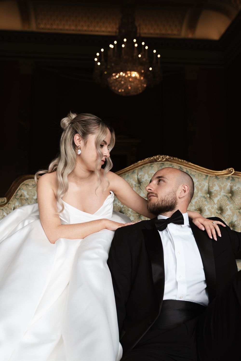 A sequence of romantic dance poses between a bride in white and groom in a black suit during their wedding celebration.