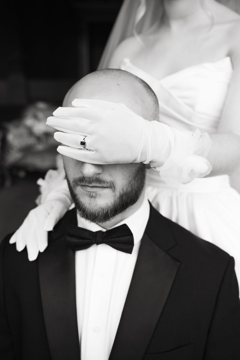 Black and white close-up image series of a groom wearing a bowtie and tuxedo, with white gloves being placed on screen.