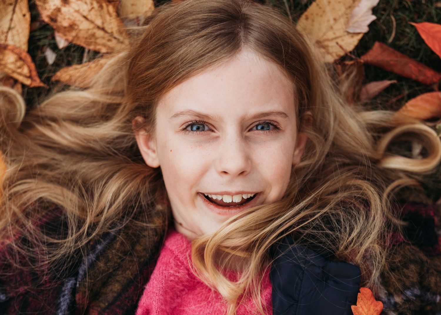 A collage of multiple images showing fall leaves, winter season, and a person wearing a red sweater outdoors.