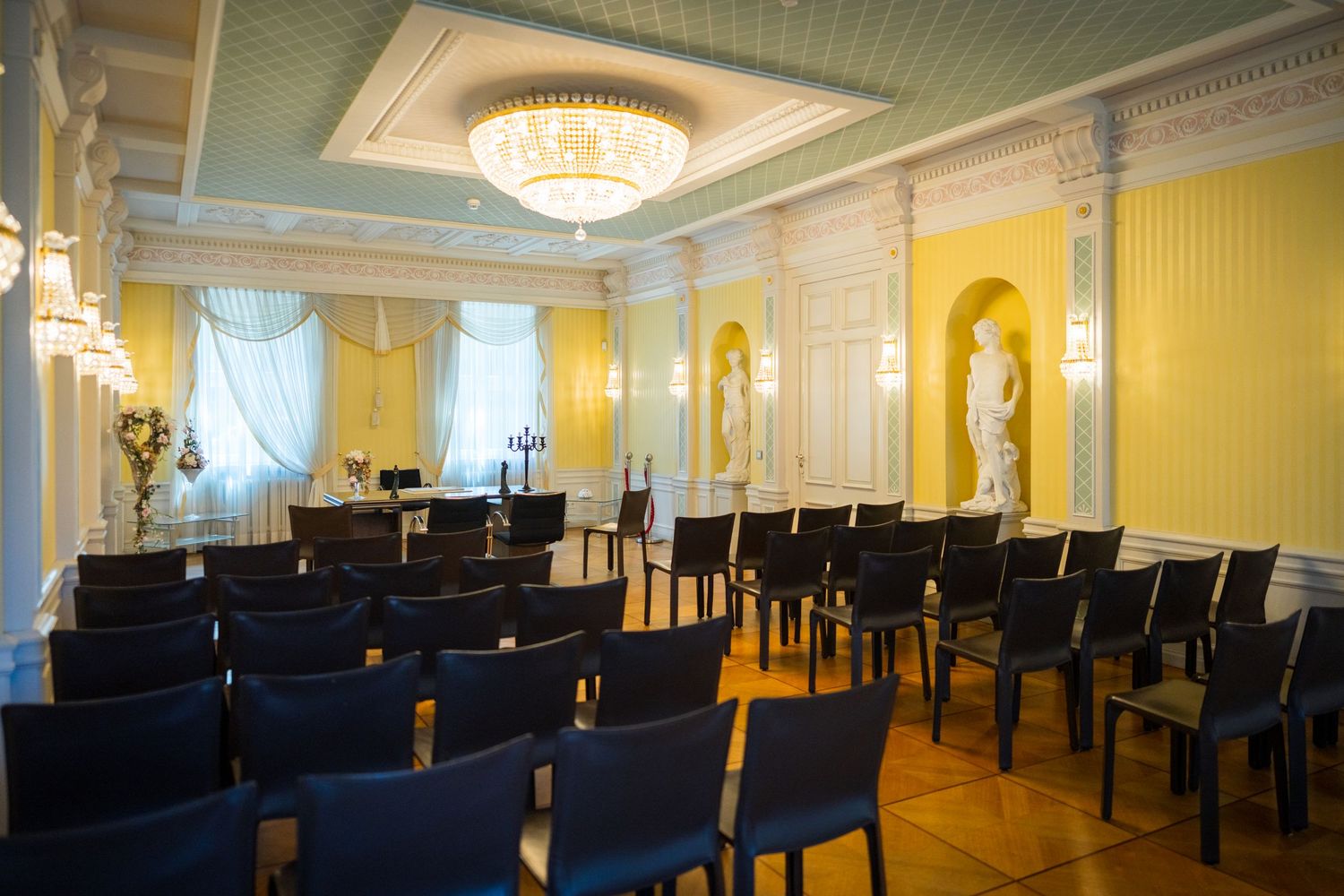 Hochzeitsfotograf Märchenvilla Eberswalde – Blick auf Stuhlreihen im gelben Trauzimmer