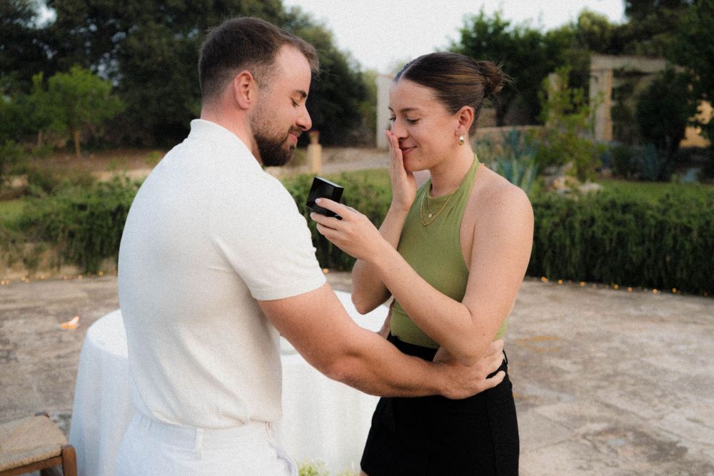 Romantic couple sharing an emotional moment during an outdoor proposal.