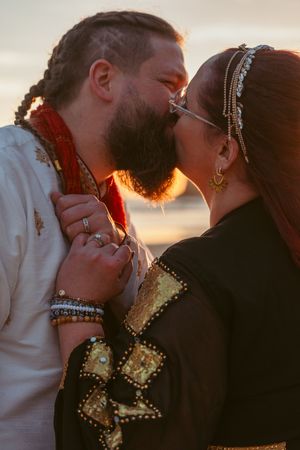 A romantic sunset moment with light glowing through jewelry and traditional wedding attire.