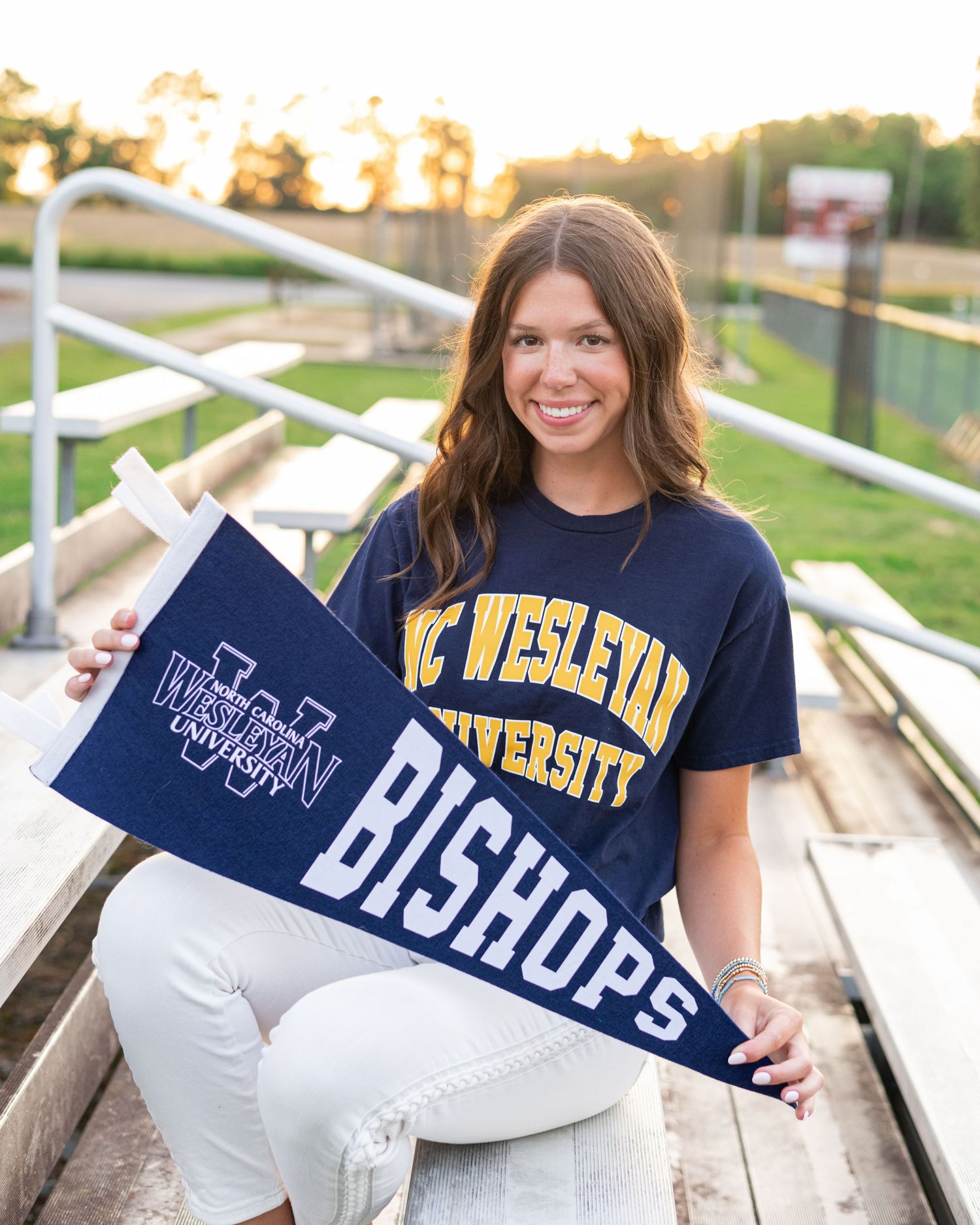 College acceptance letters and merchandise displayed on wooden bleachers.