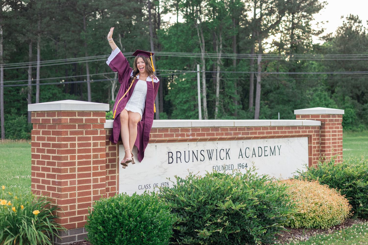 Brunswick Academy entrance sign with brick columns and landscaping in background.