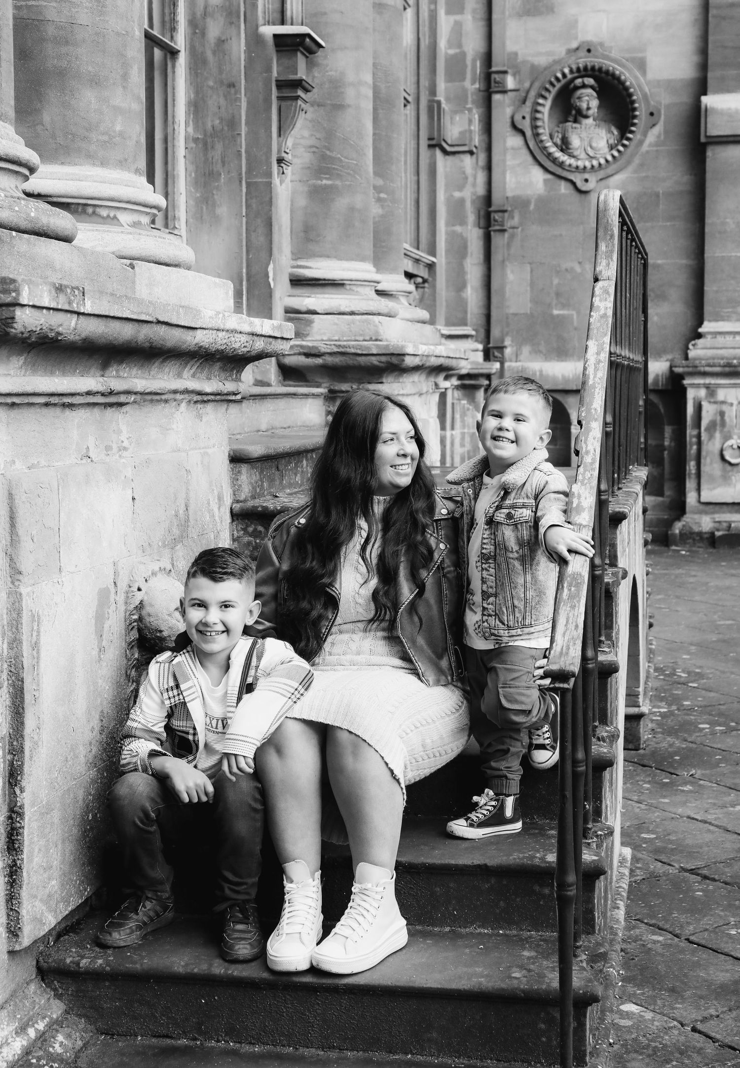 A series of black and white photographs showing Family sitting on stone steps during family shoot in Nottingham