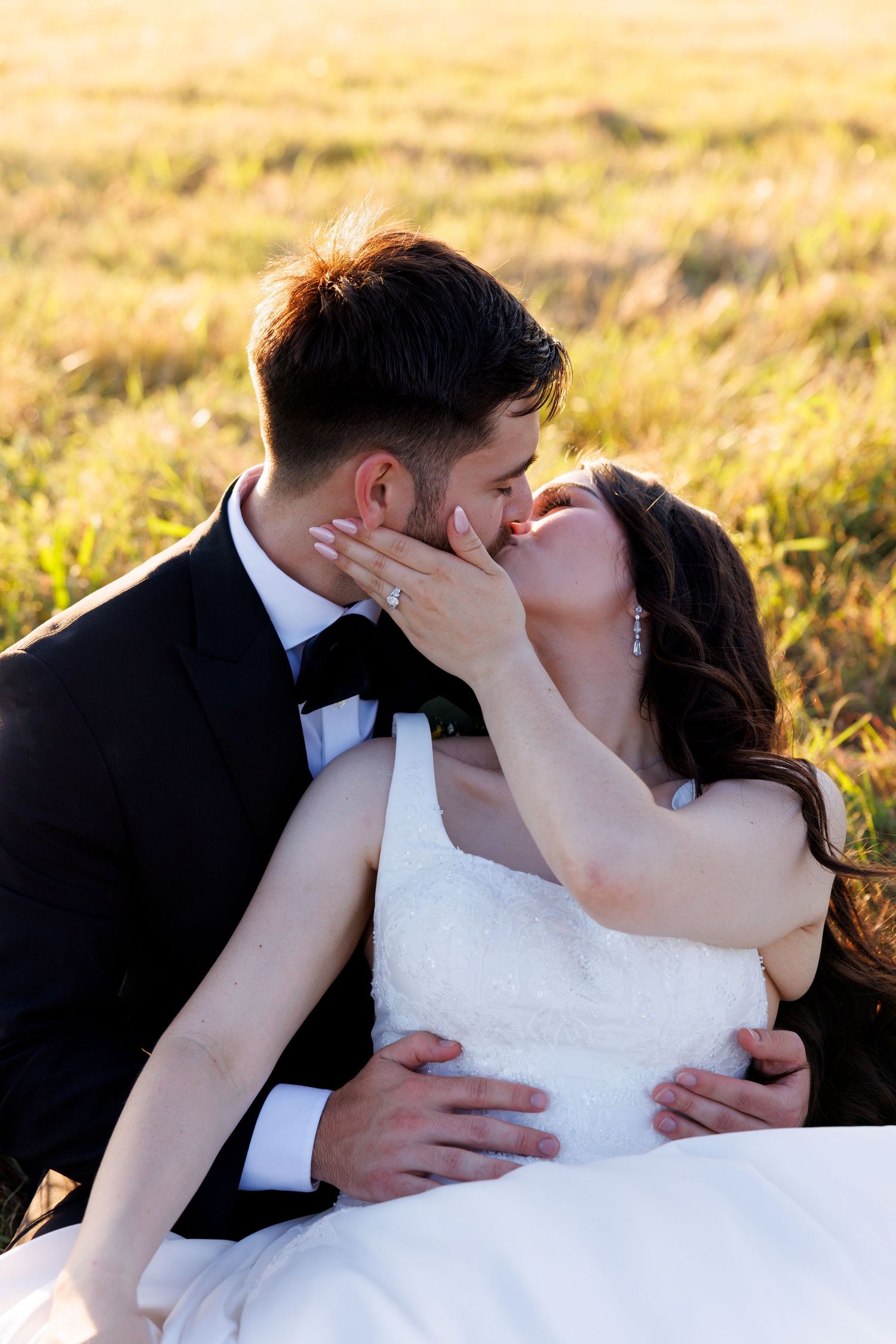 A romantic wedding portrait sequence captured in a golden sunset field.