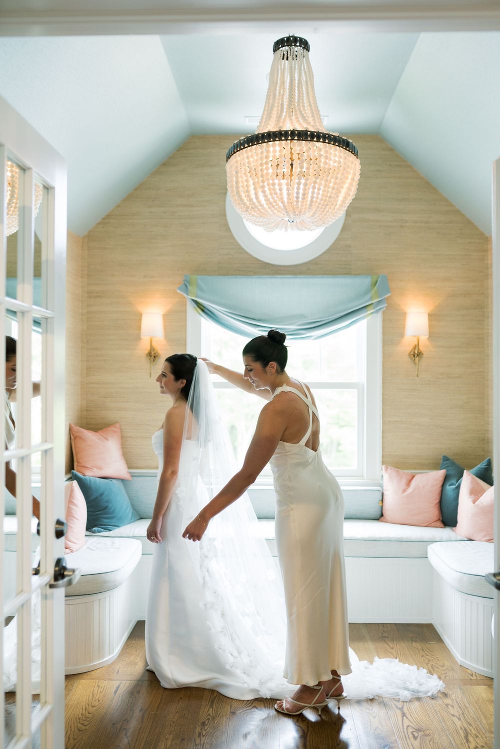 A sequence showing the movement of a white wedding dress in a beautifully lit bridal suite.