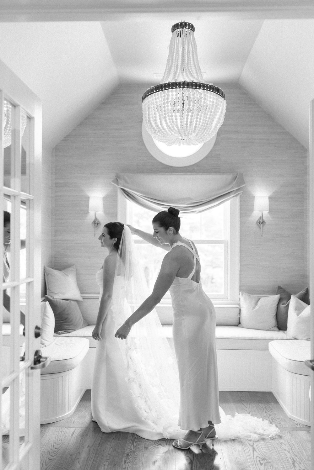 Multiple shots of a wedding dress being spun in an elegant room with crystal chandelier.