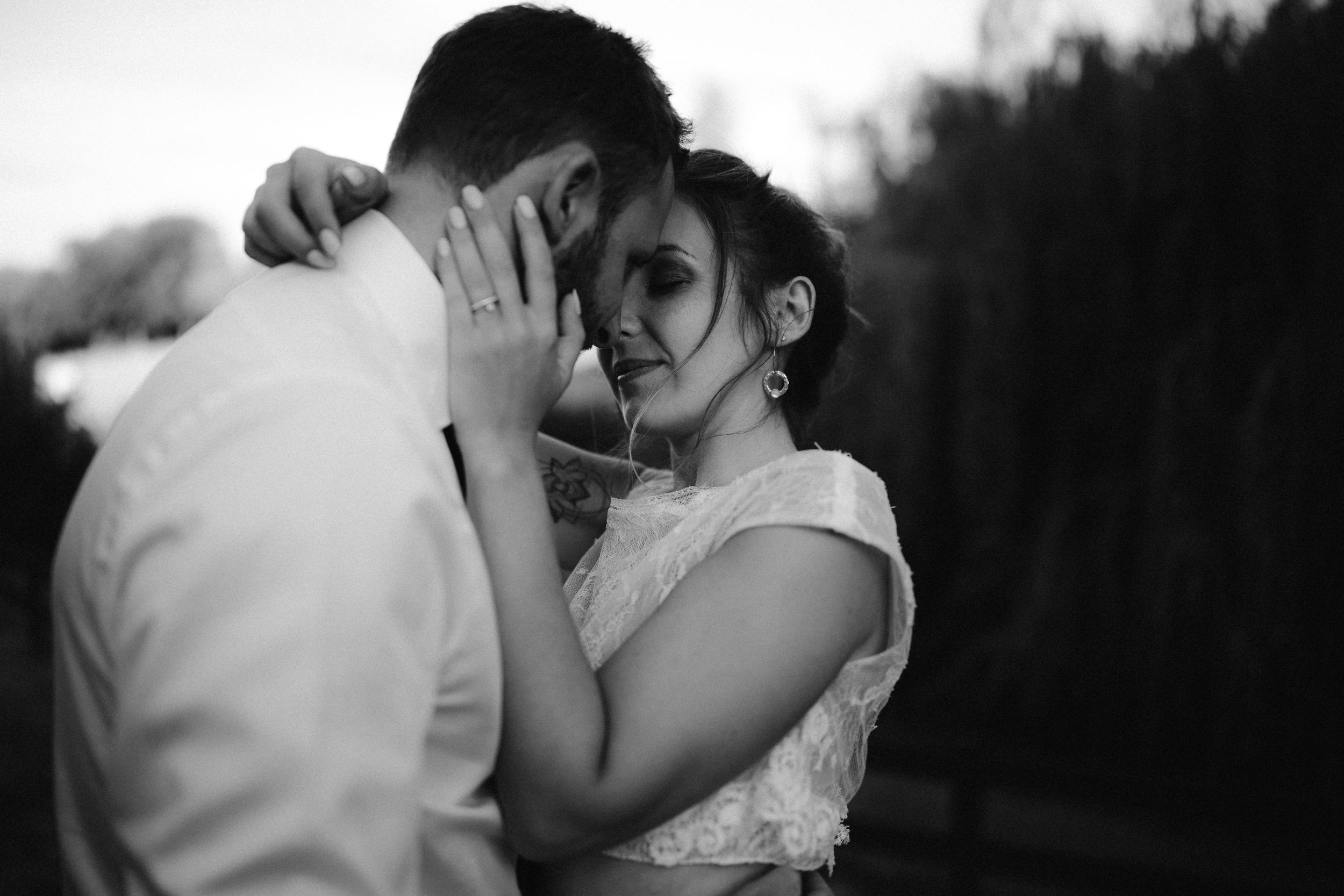An intimate black and white portrait capturing a tender embrace.