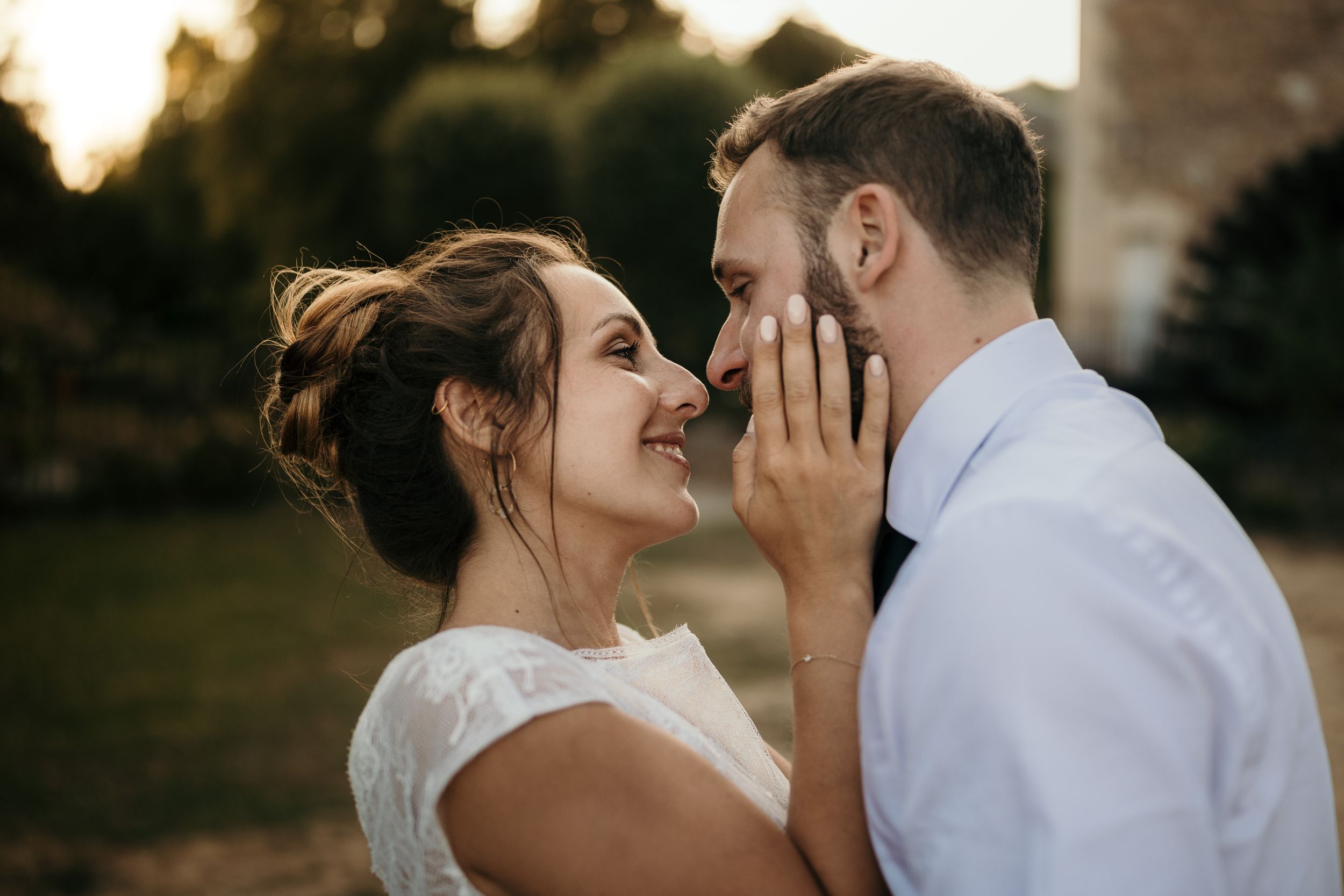 An intimate moment between a couple sharing laughter during their wedding photoshoot.