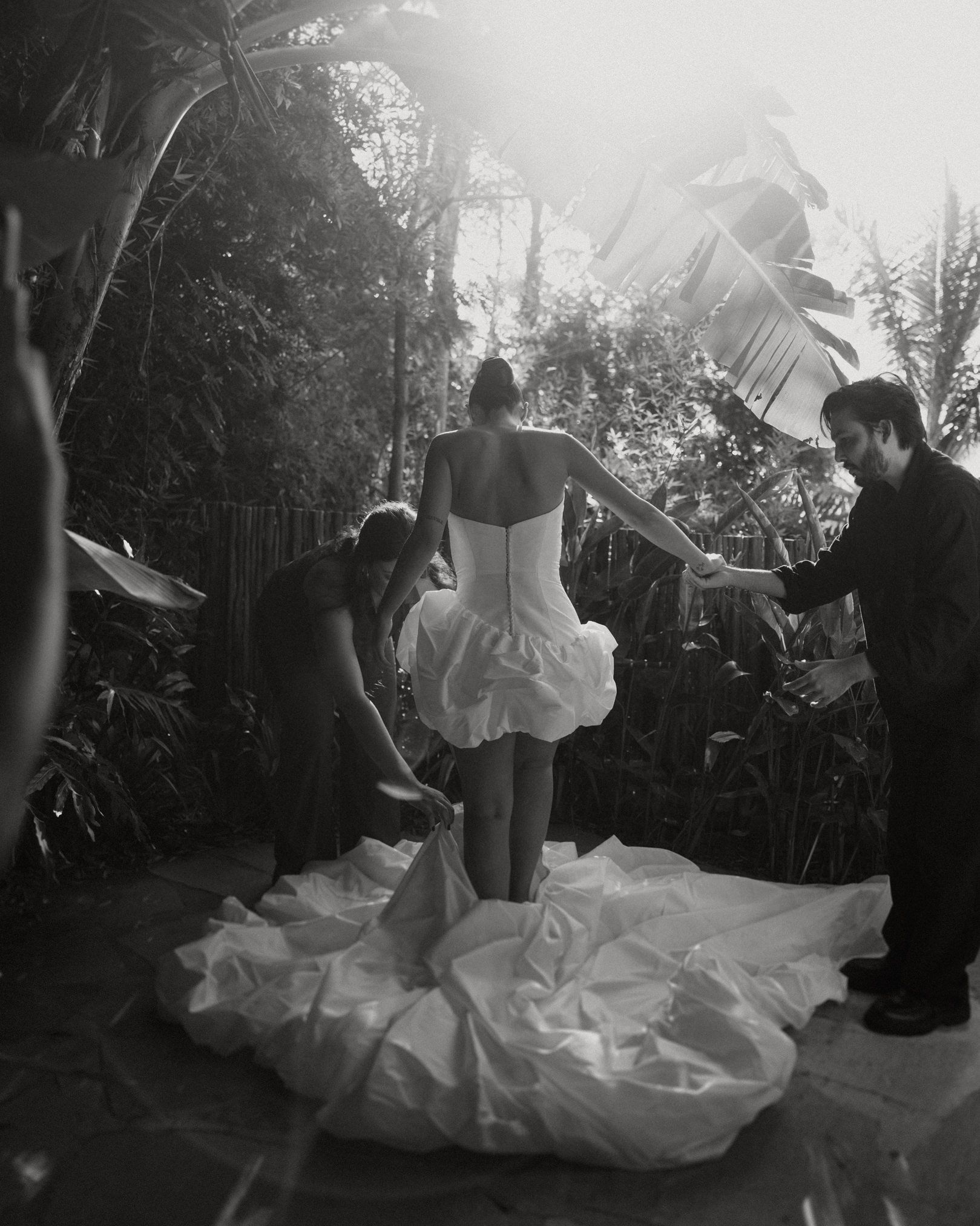 A romantic outdoor photoshoot sequence with flowing white gown movement captured in black and white style.