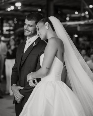 A black and white candid moment captured of a newlywed couple laughing during their special day.