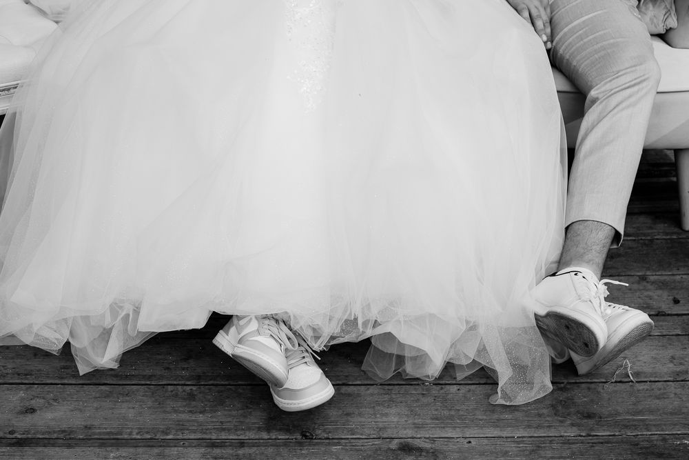 A series of wedding photos showing the bottom half of a bride and groom dancing together in formal attire.