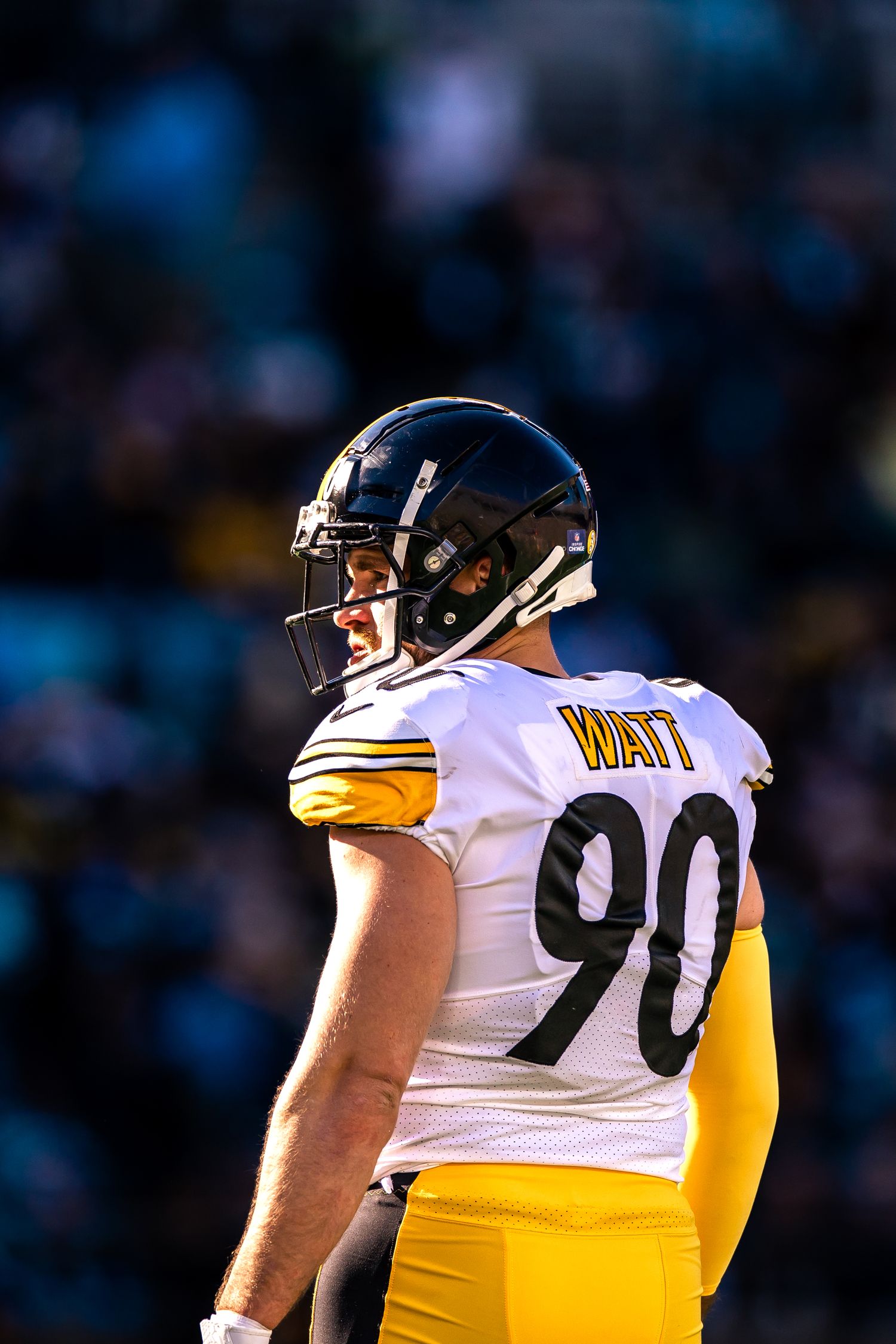 Pittsburgh Steelers defensive end T.J. Watt number 90 stands in white and gold uniform.