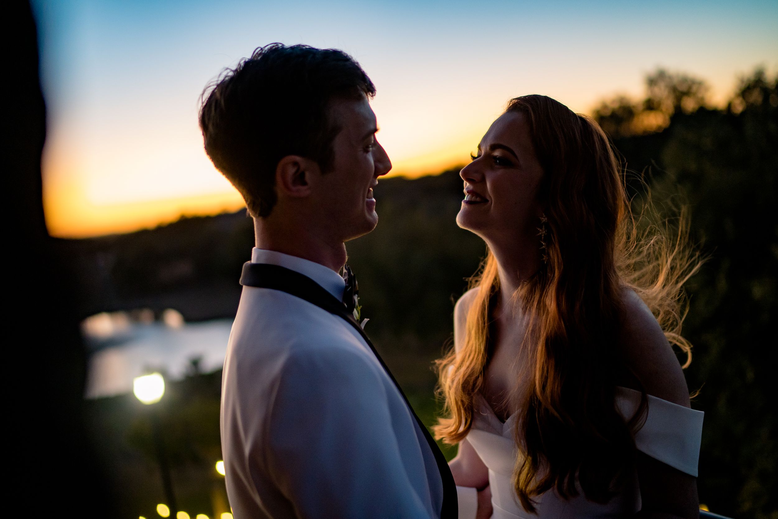 A romantic golden hour wedding photo shoot with scenic outdoor lighting during sunset.
