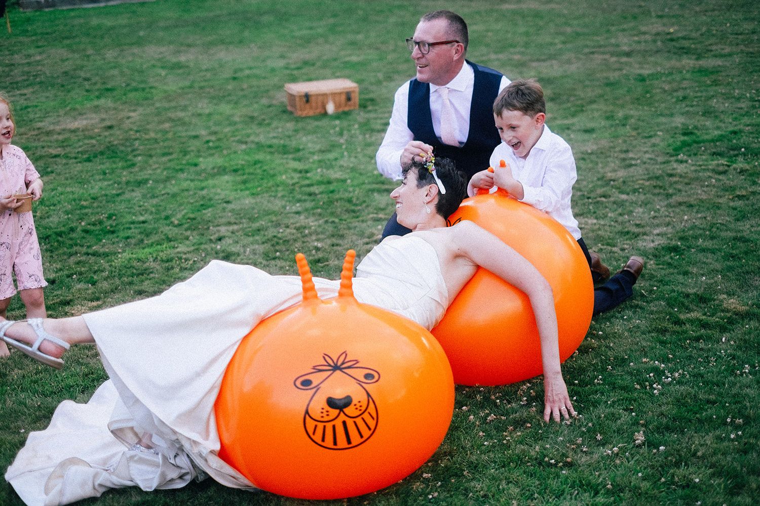 Black and white candid photos capture joyful laughter at a wedding reception gathering.