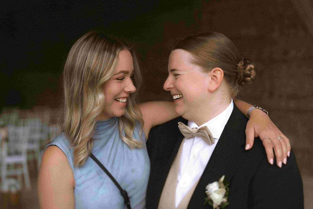 Intimate black and white photograph of a joyful wedding celebration moment.