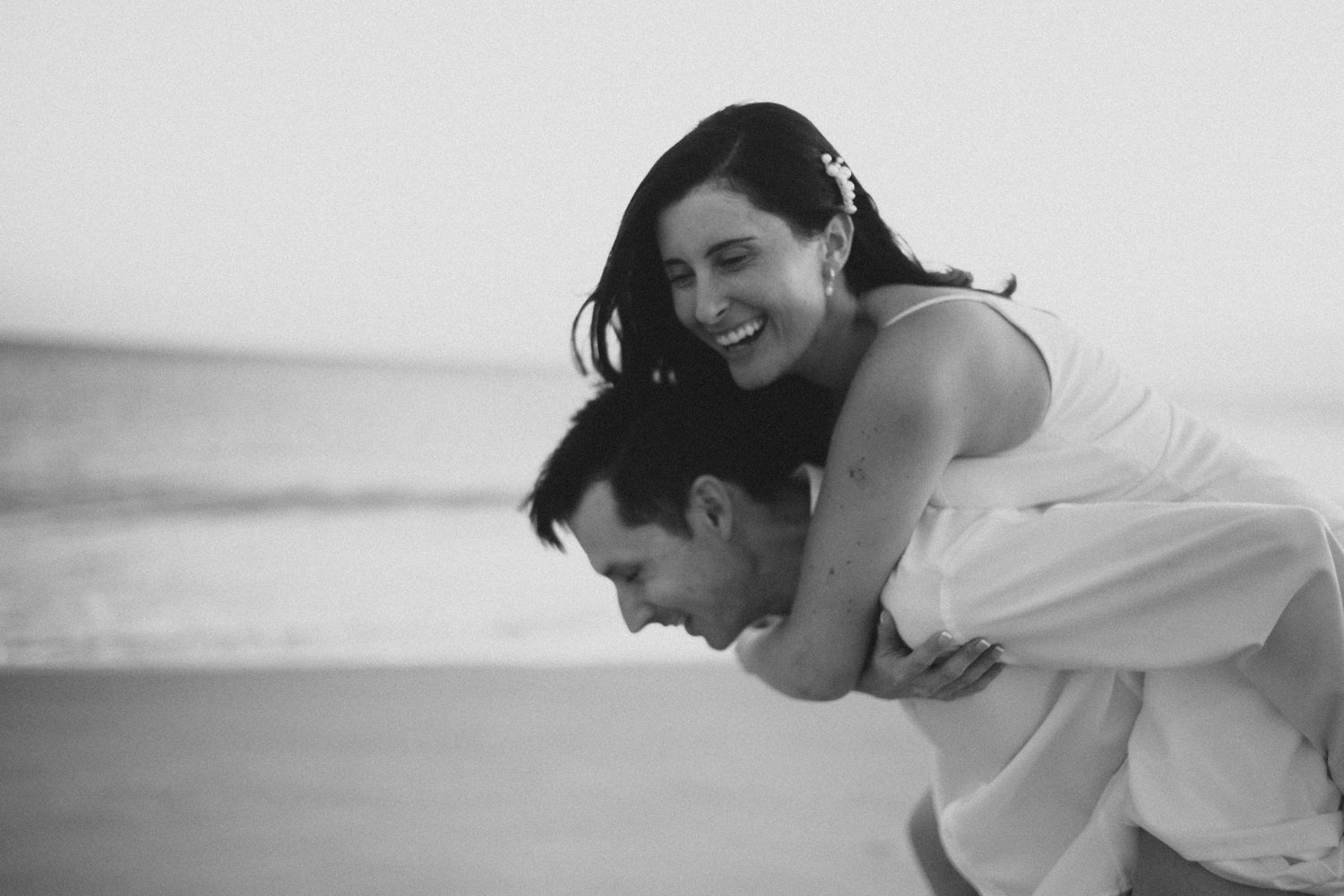 A series of black and white photos showing a couple embracing and sharing tender moments together.