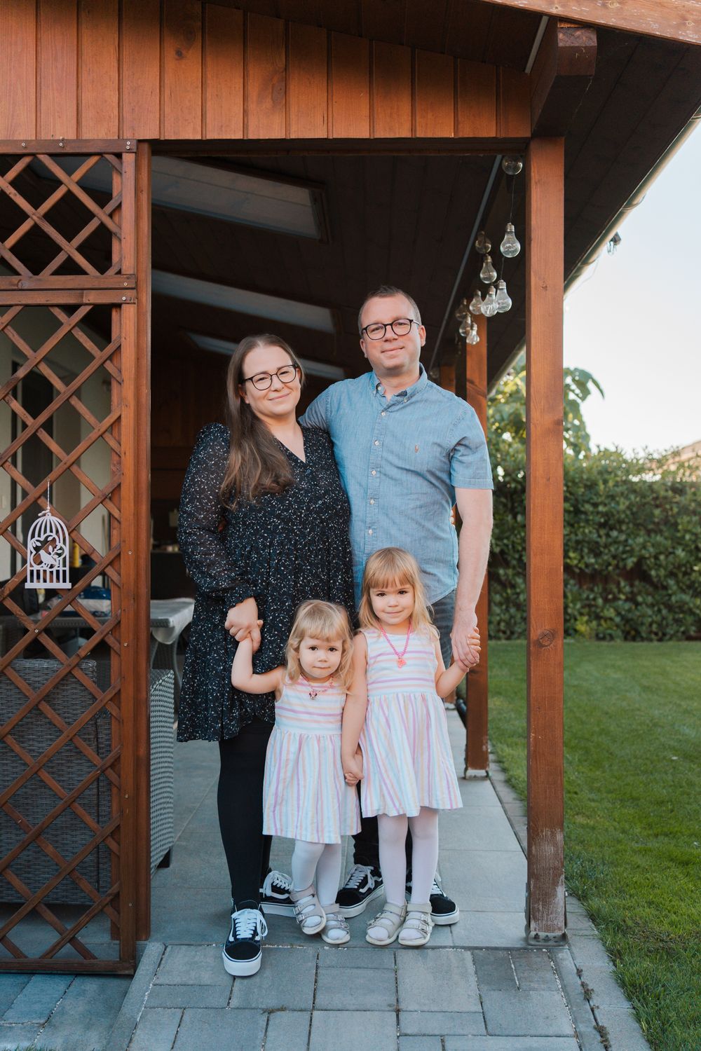 Three coordinated family photos show a group standing on a porch in matching outfits with lattice woodwork behind them in Rouse Hill Sydney