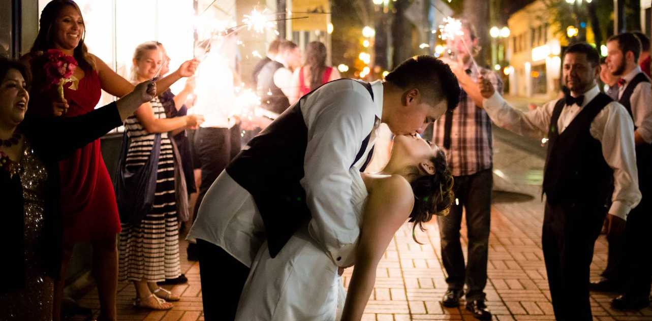 A Portland, Oregon wedding reception exit with sparklers and a dramatic sweeping kiss. Asian Wedding.