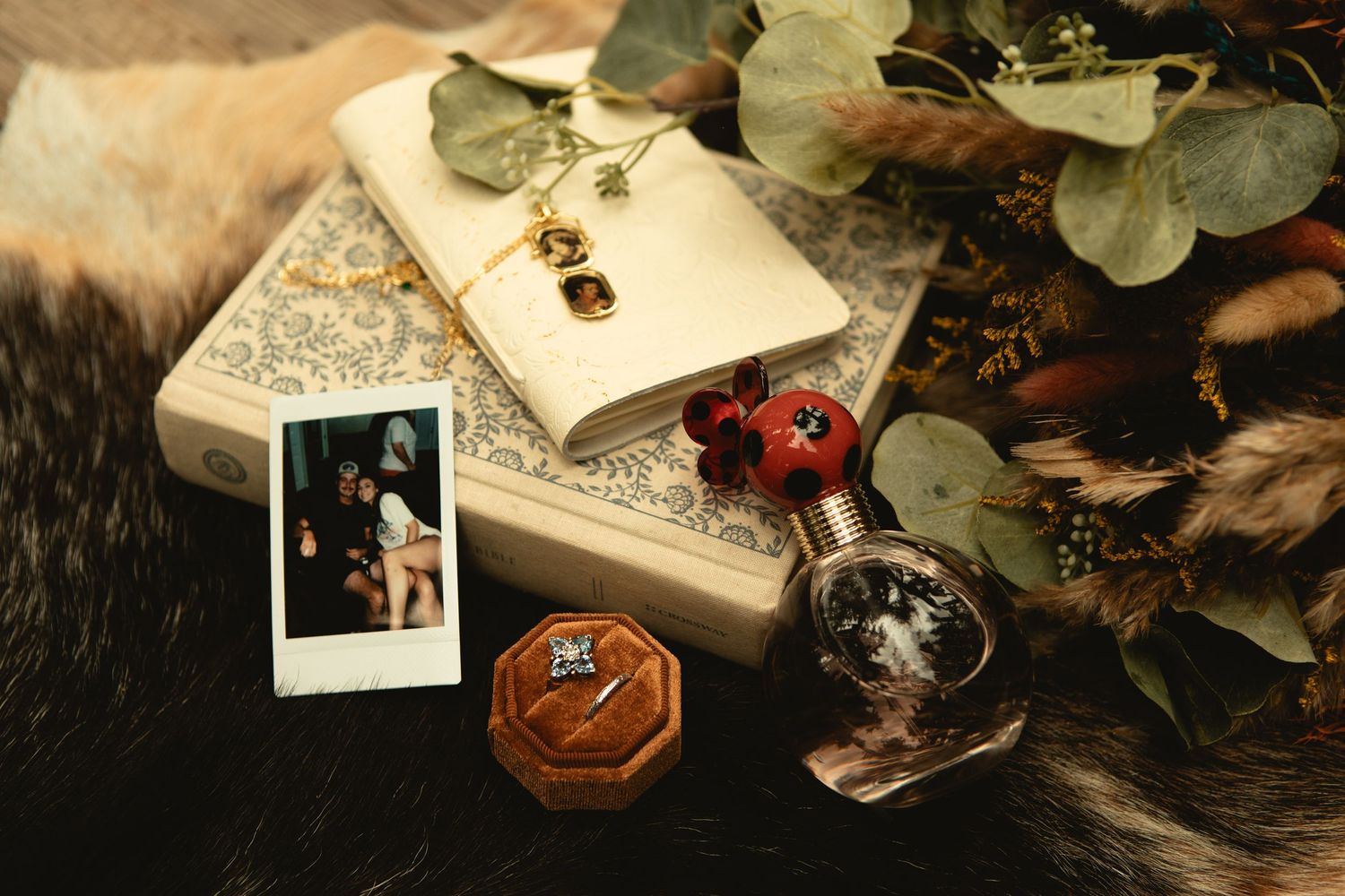 Detail shot of polaroid photos, ring, bible and vows