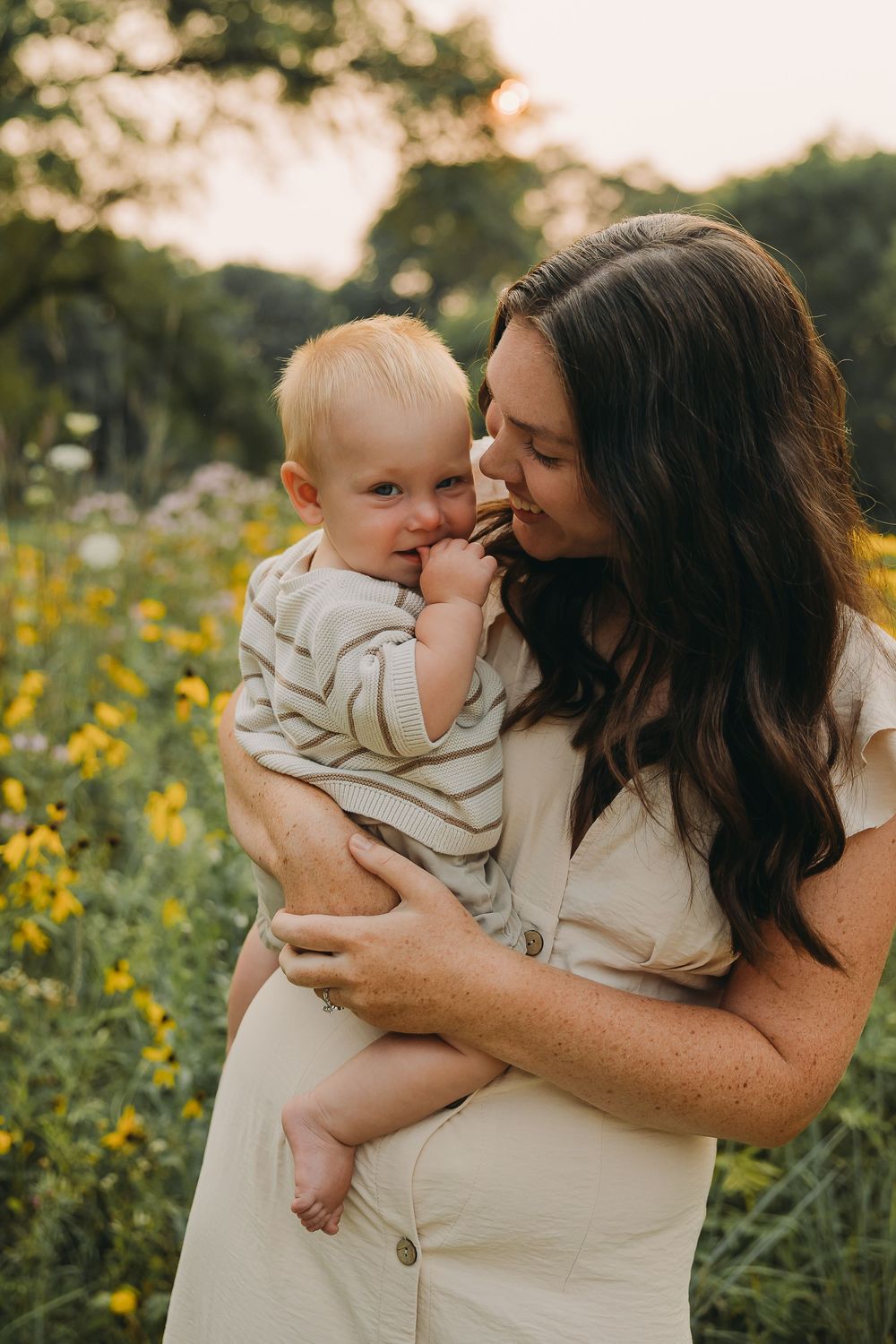 A tender moment captured in a field of yellow wildflowers during golden hour.