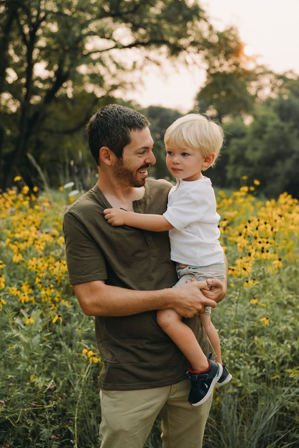 A heartwarming moment in a field of yellow wildflowers during golden hour.