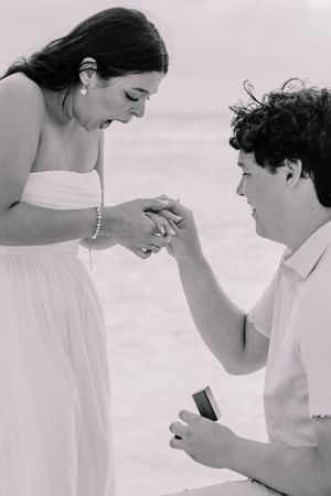 Black and white sequence capturing an emotional beach proposal moment.