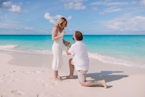 Eagle Beach proposal with turquoise ocean backdrop.