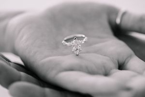 Black and white macro shot of engagement rings showcasing intricate diamond details.