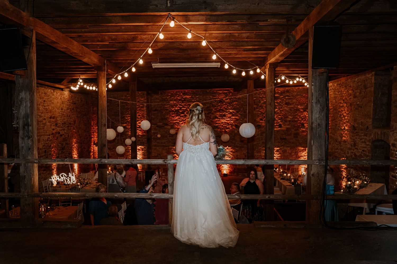 Intimate romantic couple sharing tender kisses in moody lighting with warm orange glow.