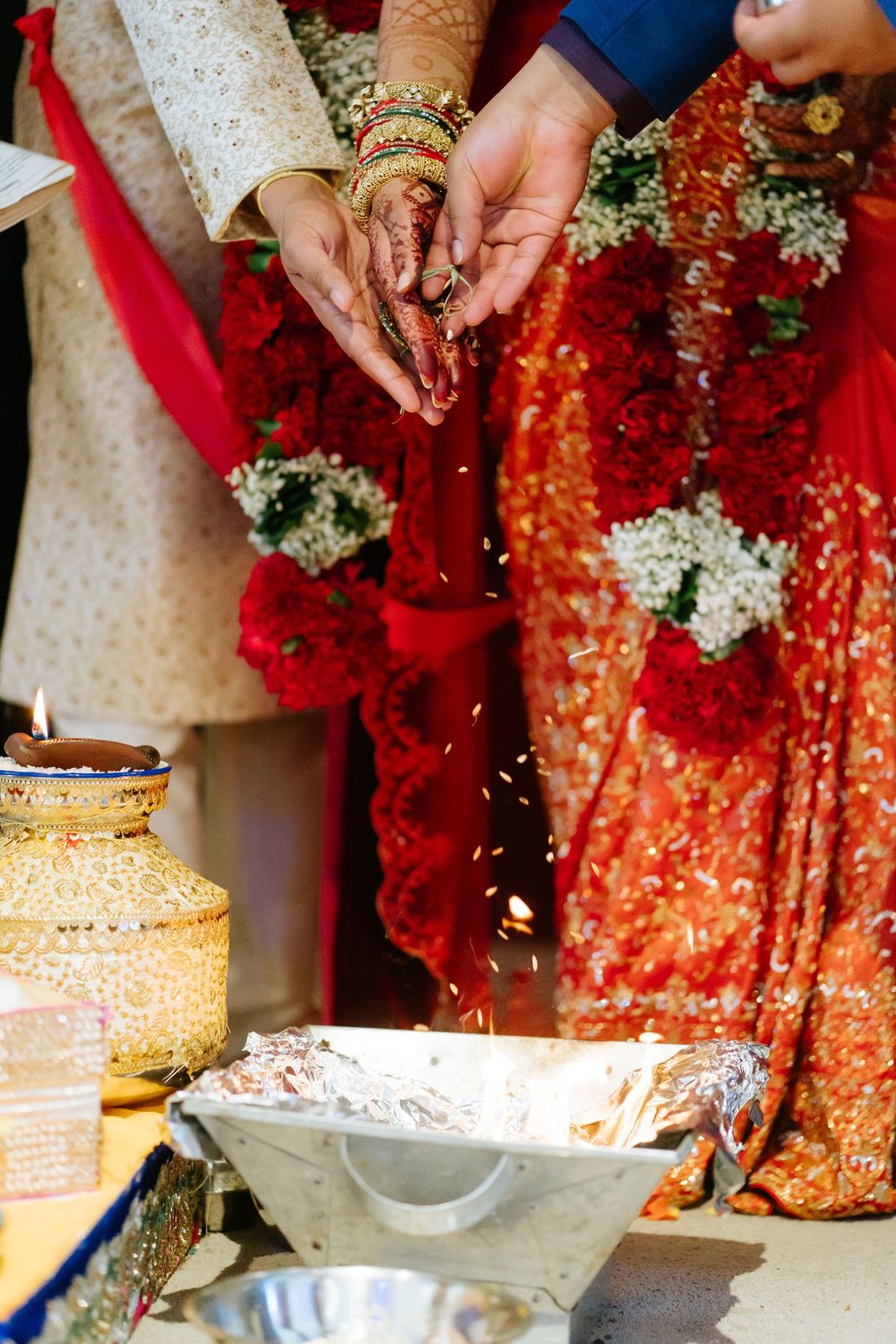 Close-up shots of traditional Indian wedding ceremony rituals with red and gold decorative elements.