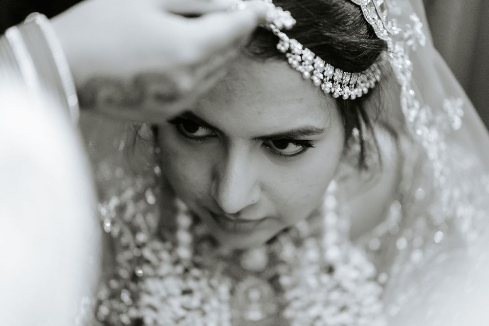 Artistic black and white close-up portraits showing intricate bridal jewelry and makeup details.