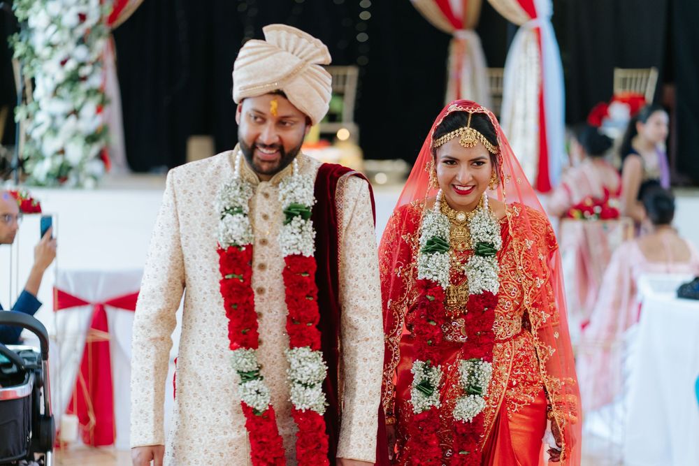 Wedding guests dancing and celebrating on a dance floor at an Indian reception.