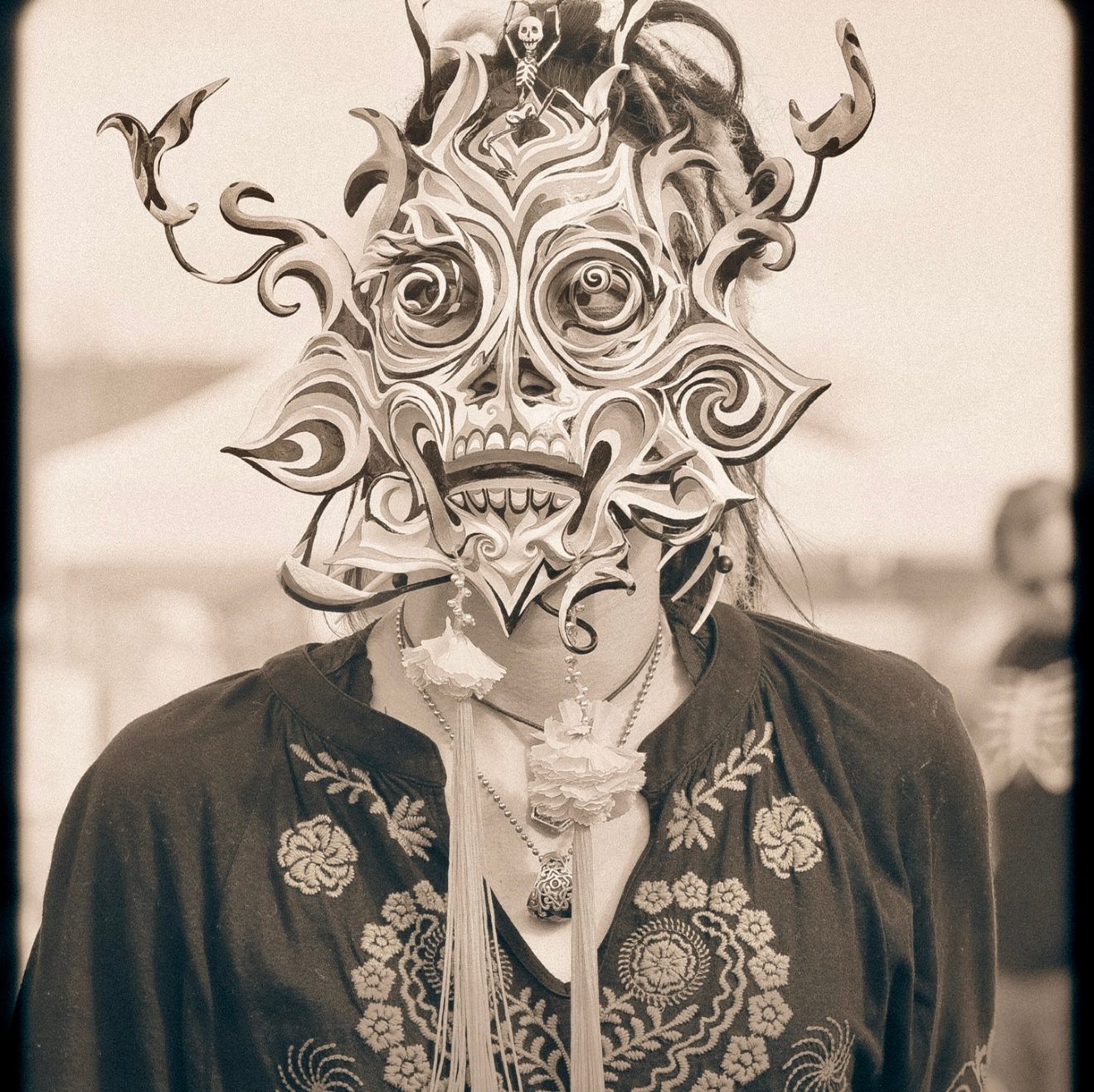 Artistic black and white portrait series featuring ornate decorative masks.