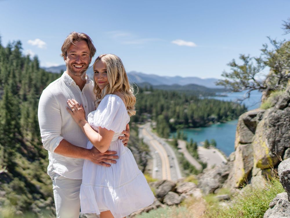 A romantic mountain engagement photo shoot with stunning lake and forest views in the background.