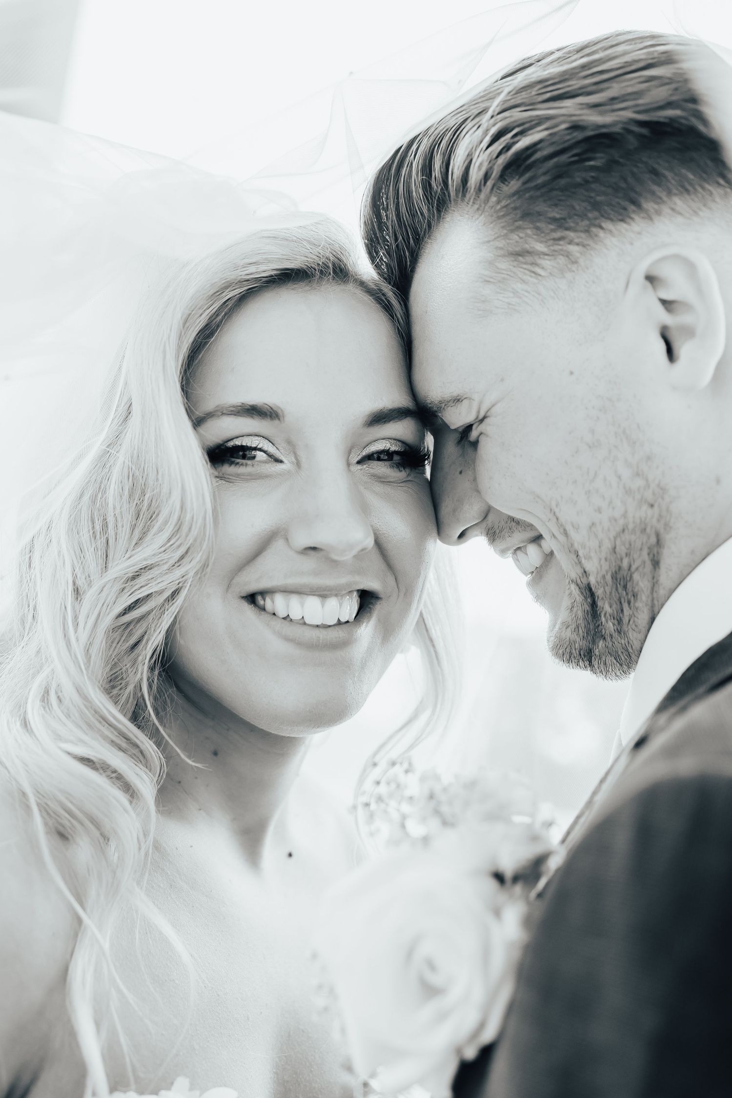 A romantic black and white photo series showing tender moments between a couple sharing intimate glances and laughter.