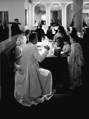 A vintage black and white photo of guests seated at tables during a formal dinner event.