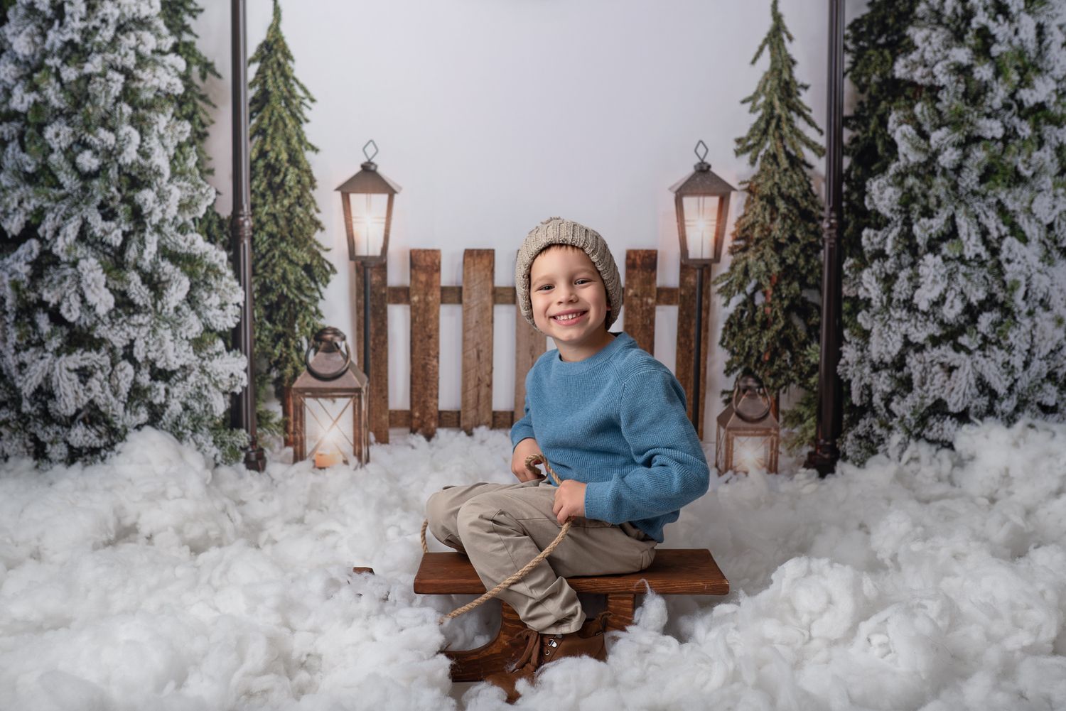A series of winter photos showing someone posing in front of snow-covered evergreen trees and a rustic wooden fence.