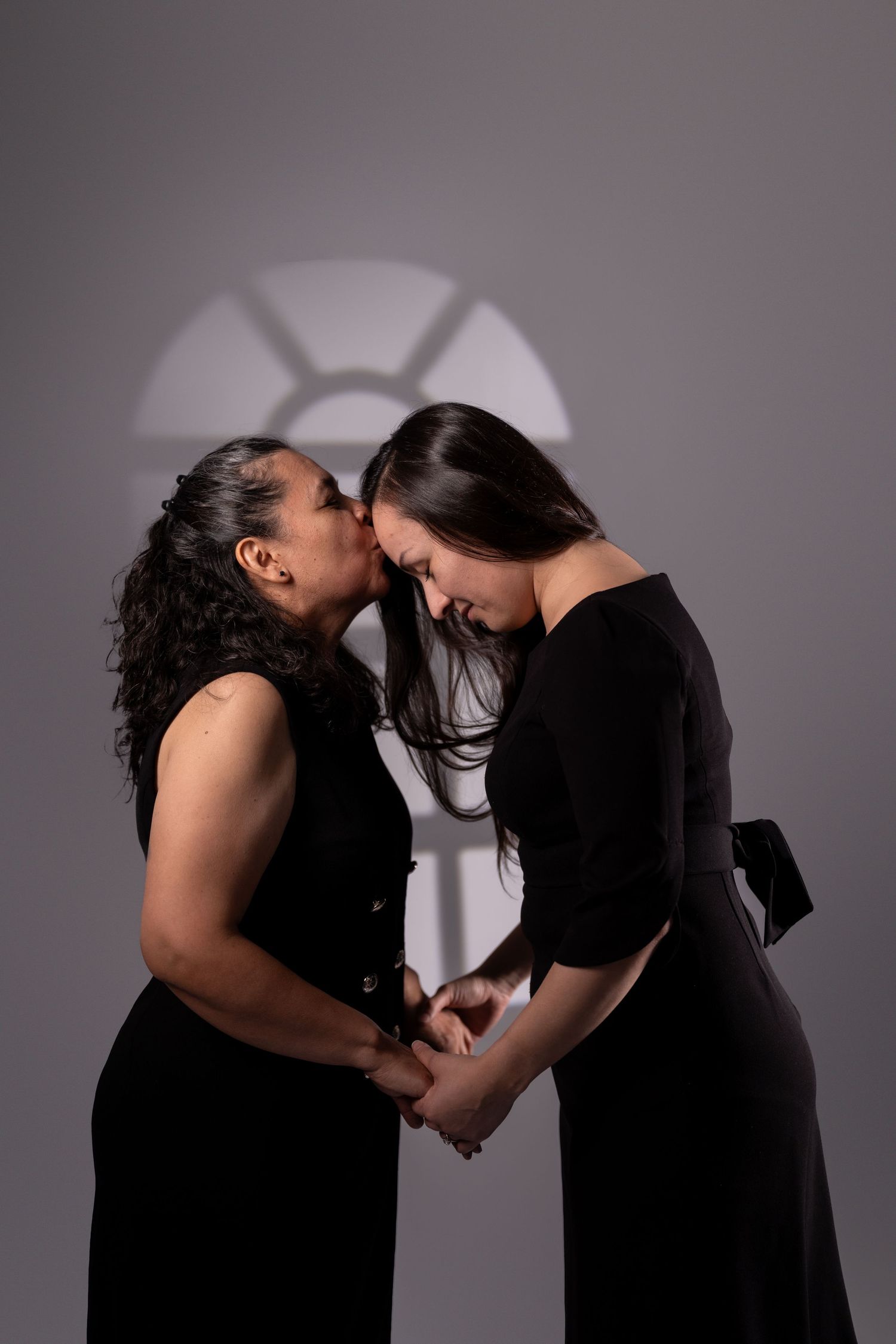 Emotional black and white portrait series with window lighting effects.