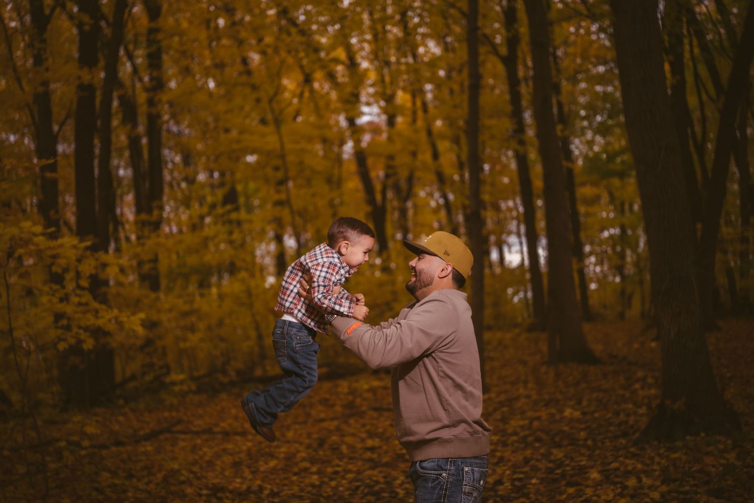 Playful interaction captured in a forest setting during autumn.
