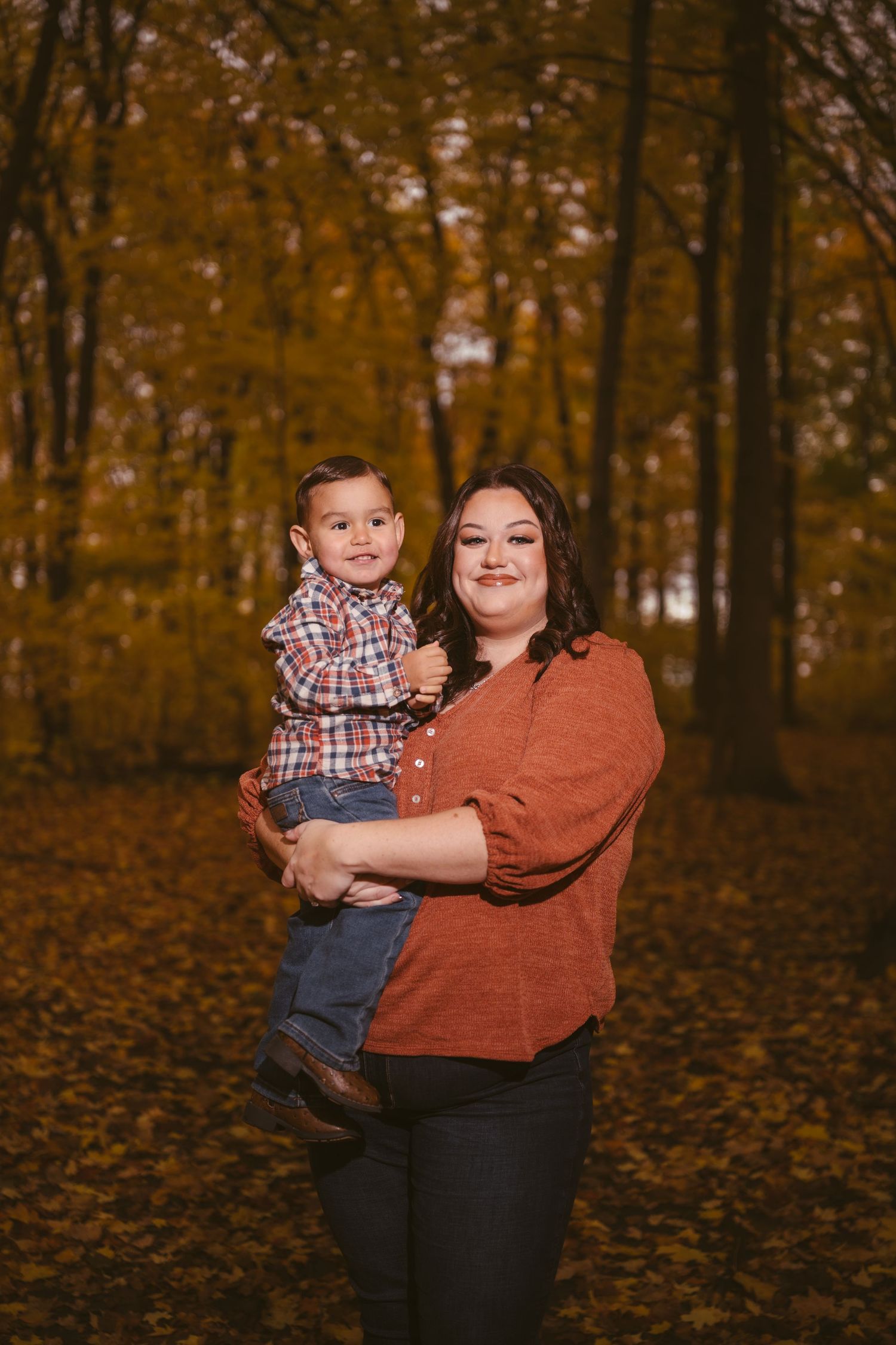 A heartwarming autumn portrait taken in a forest with golden leaves.