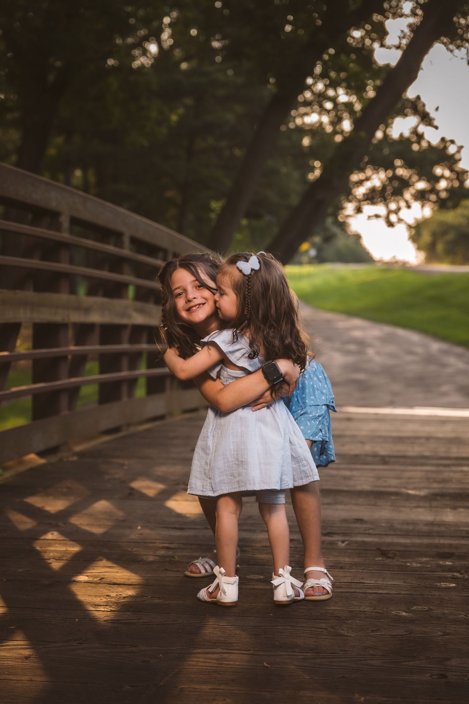 A series of photos showing two children playing together on a wooden bridge at sunset.
