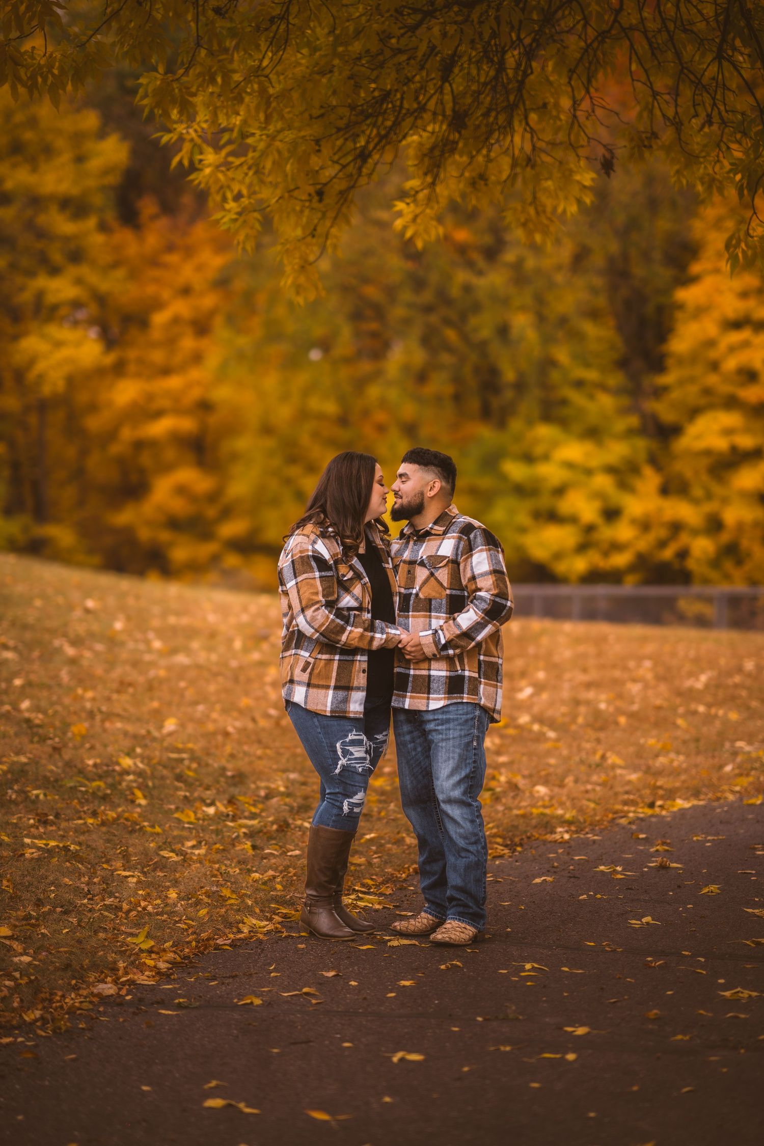 Romantic autumn photo session with couple in matching plaid shirts.