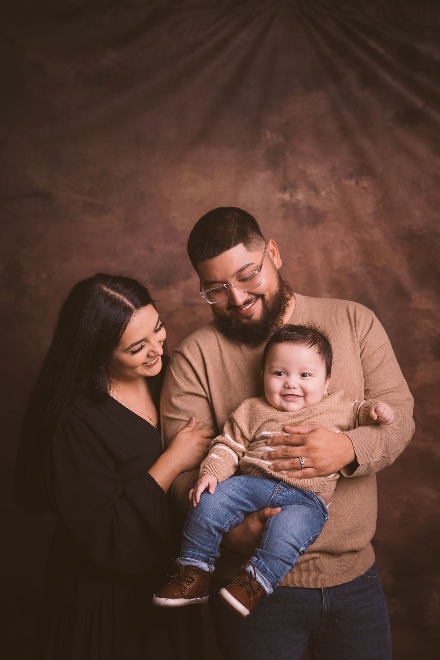 Sweet family interactions captured during indoor studio photography session.