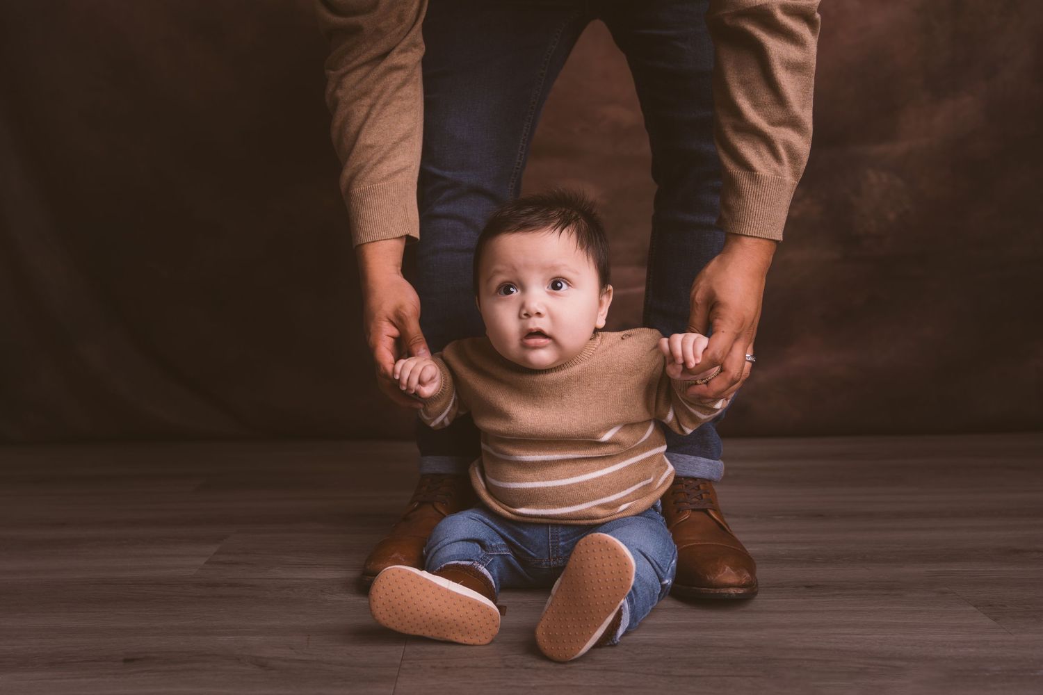 Artistic family photo series with minimalist brown studio background.