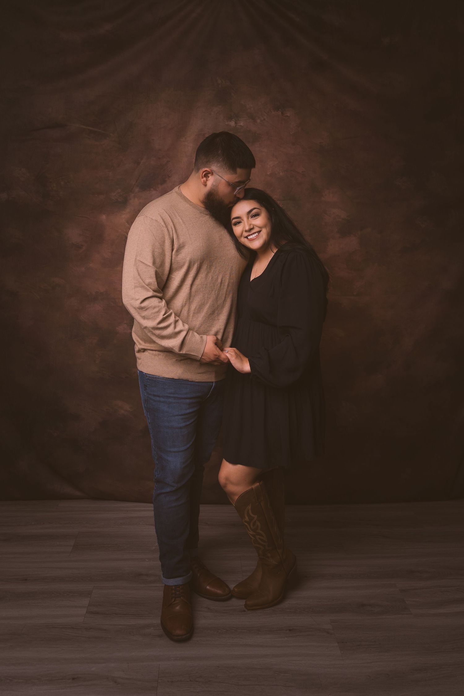 Intimate studio portraits showing a couple in casual attire against a dark brown background.