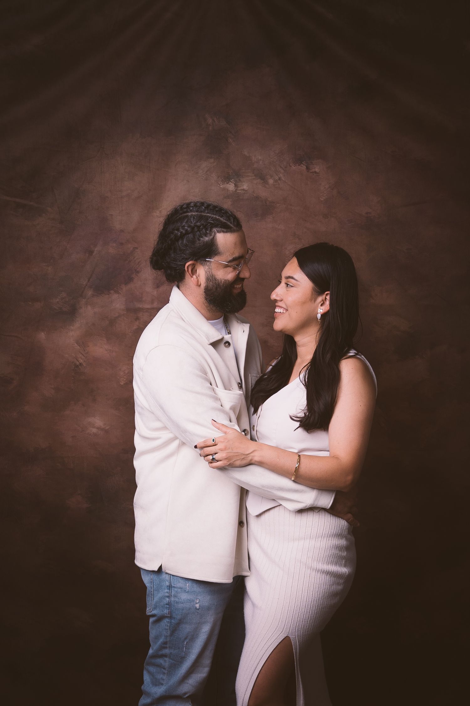 An intimate portrait of a couple sharing a tender moment in formal attire.
